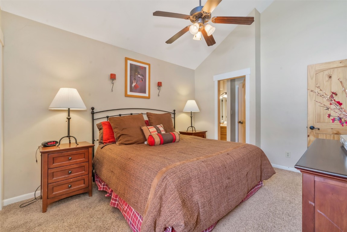 2025 Walton Creek Road, Unit 401 Steamboat Springs, CO 80487 - Photo 24 of 38 a bedroom with a bed and a lamp on dresser