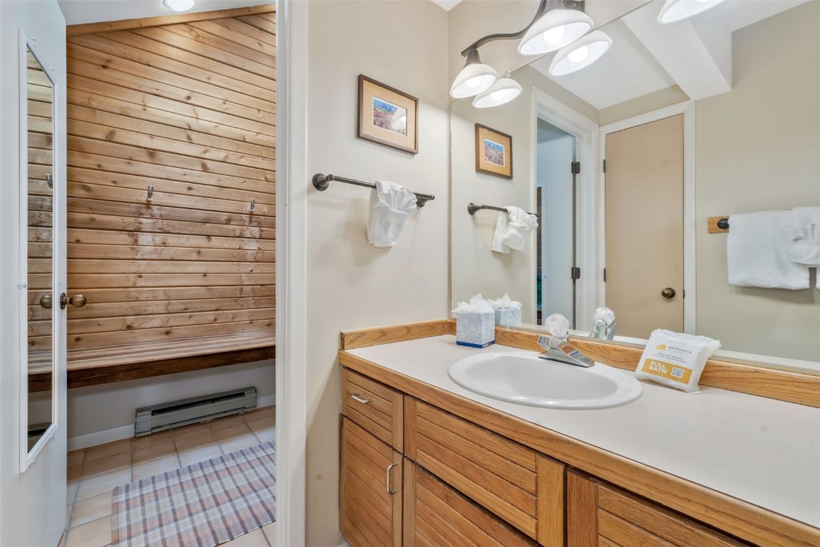 2025 Walton Creek Road, Unit 401 Steamboat Springs, CO 80487 - Photo 26 of 38 a bathroom with a sink and a mirror