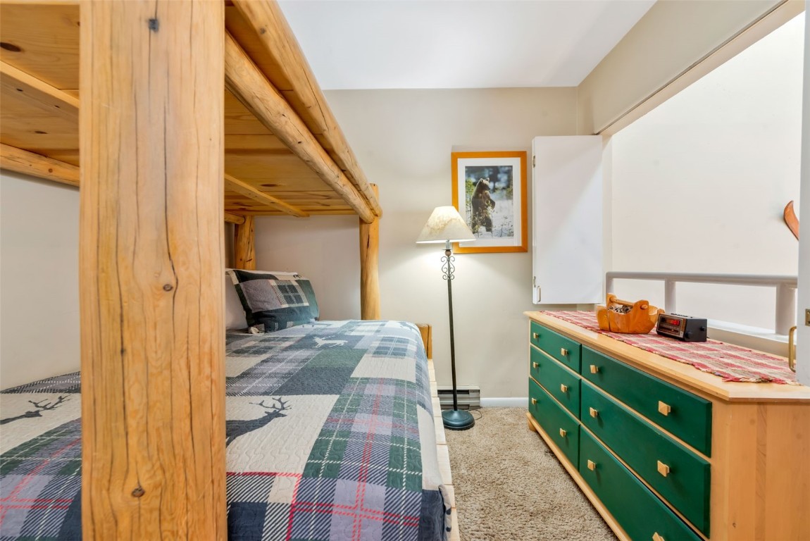 2025 Walton Creek Road, Unit 401 Steamboat Springs, CO 80487 - Photo 30 of 38 a view of a bedroom with a bed and furniture