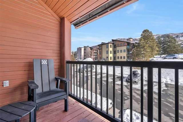 a view of a balcony with wooden fence and floor