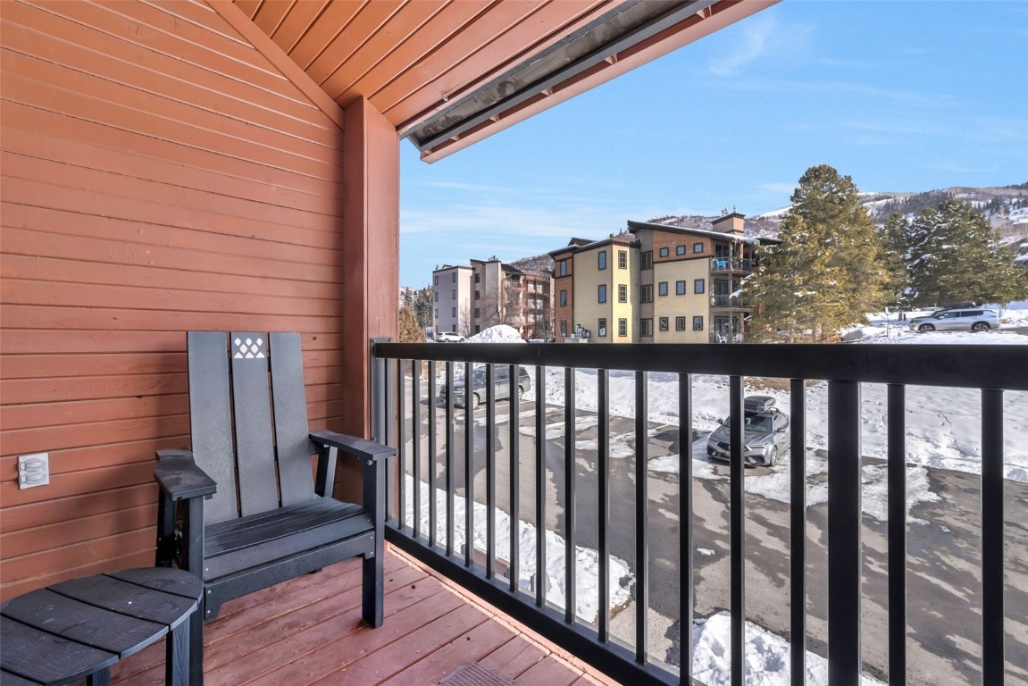 2025 Walton Creek Road, Unit 401 Steamboat Springs, CO 80487 - Photo 32 of 38 a view of a balcony with wooden fence and floor