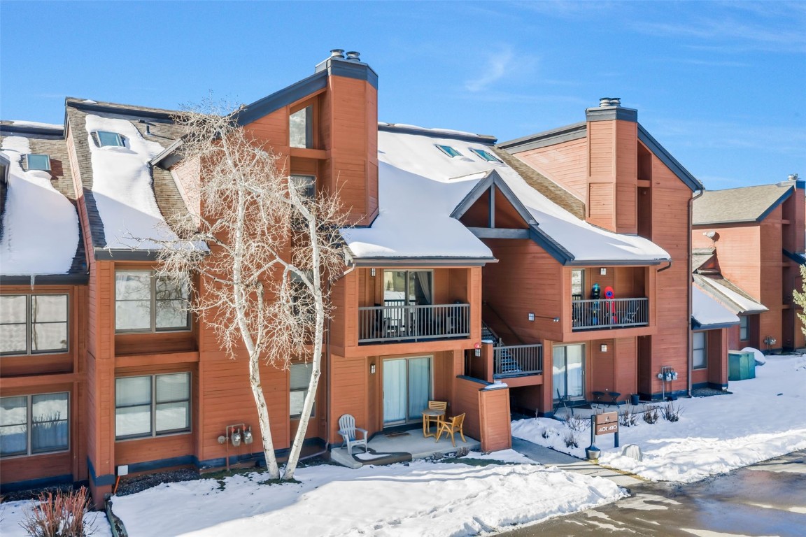 2025 Walton Creek Road, Unit 401 Steamboat Springs, CO 80487 - Photo 35 of 38 a front view of a house with a tree