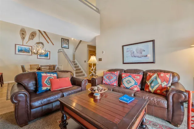 a living room with furniture and painting on the wall