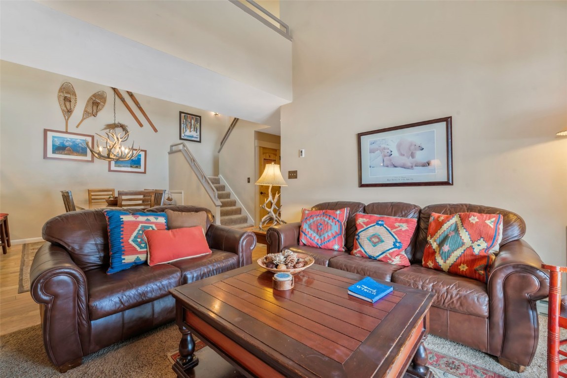2025 Walton Creek Road, Unit 401 Steamboat Springs, CO 80487 - Photo 4 of 38 a living room with furniture and painting on the wall