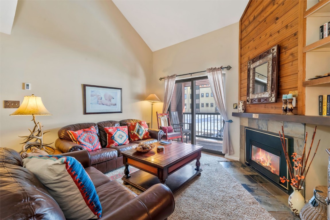 2025 Walton Creek Road, Unit 401 Steamboat Springs, CO 80487 - Photo 5 of 38 a living room with furniture and a fireplace