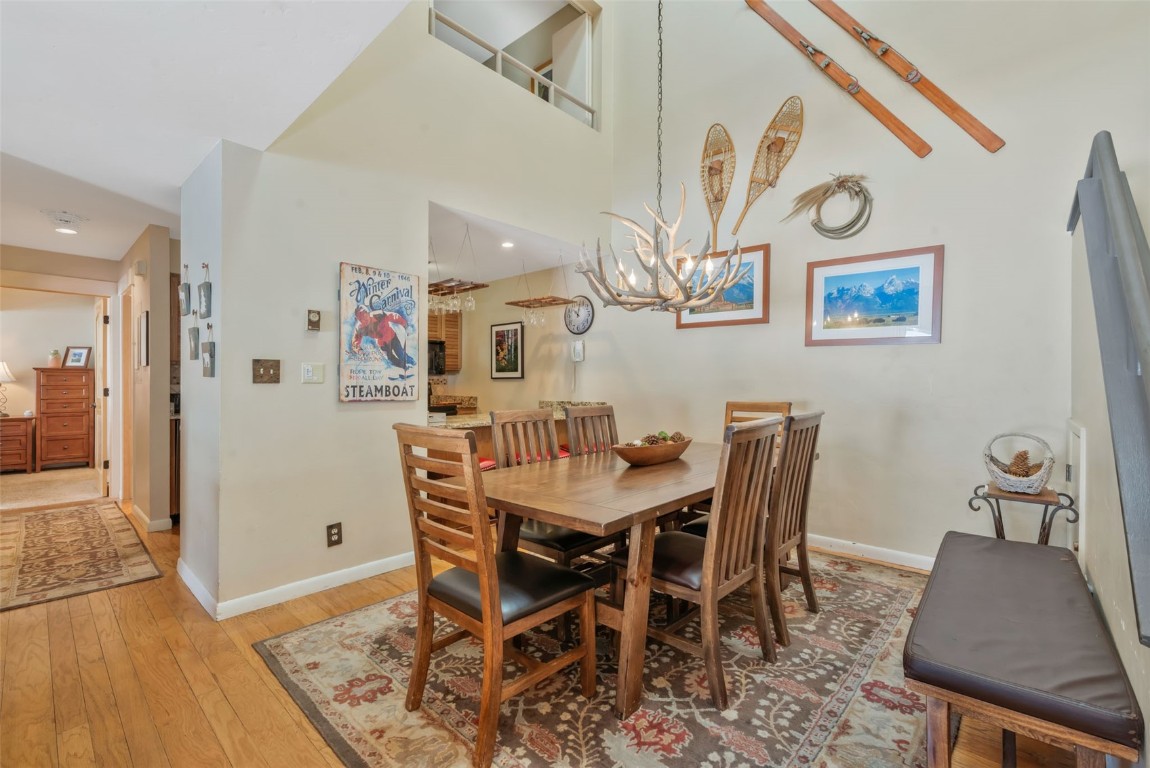 2025 Walton Creek Road, Unit 401 Steamboat Springs, CO 80487 - Photo 7 of 38 a view of a dining room with furniture and wooden floor