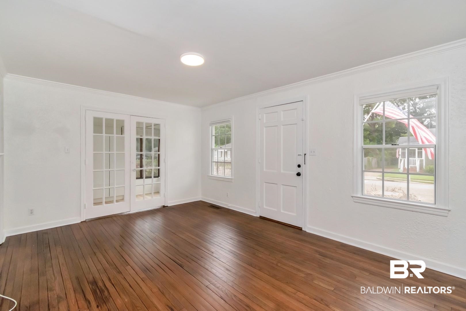 208 Morgan Avenue Mobile, AL 36606 - Photo 6 of 27 Entrance foyer with a healthy amount of sunlight, ornamental molding, and dark wood-type flooring