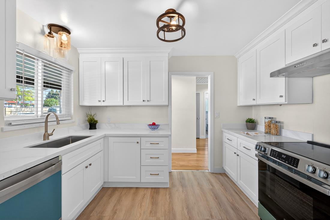 2991-2987 Almaden Road San Jose, CA 95125 - Photo 22 of 60 a kitchen with granite countertop a sink cabinets wooden floor and stainless steel appliances