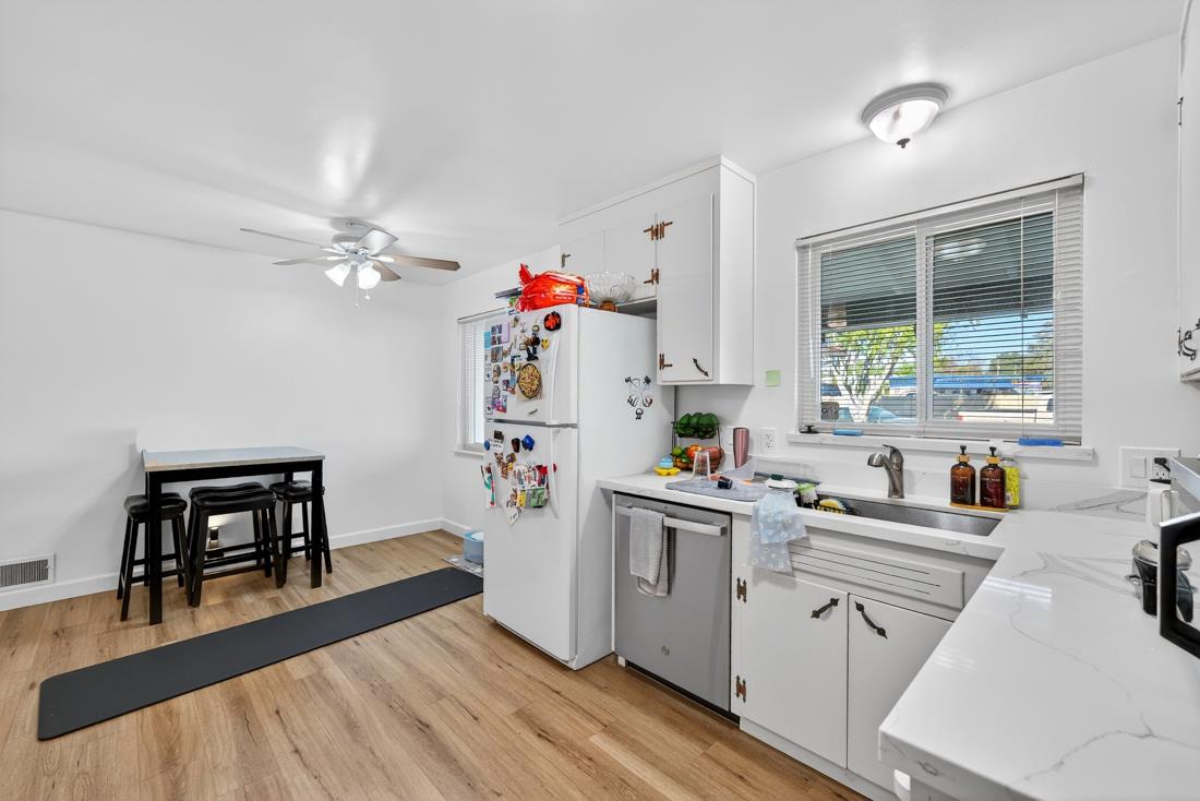 2991-2987 Almaden Road San Jose, CA 95125 - Photo 45 of 60 a kitchen with a sink dishwasher and white cabinets with wooden floor