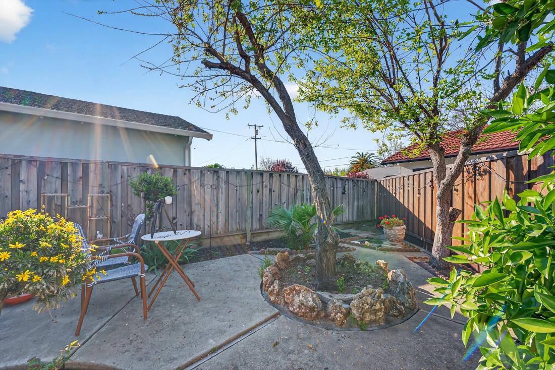 2991-2987 Almaden Road San Jose, CA 95125 - Photo 57 of 60 a backyard with table and chairs potted plants and wooden fence