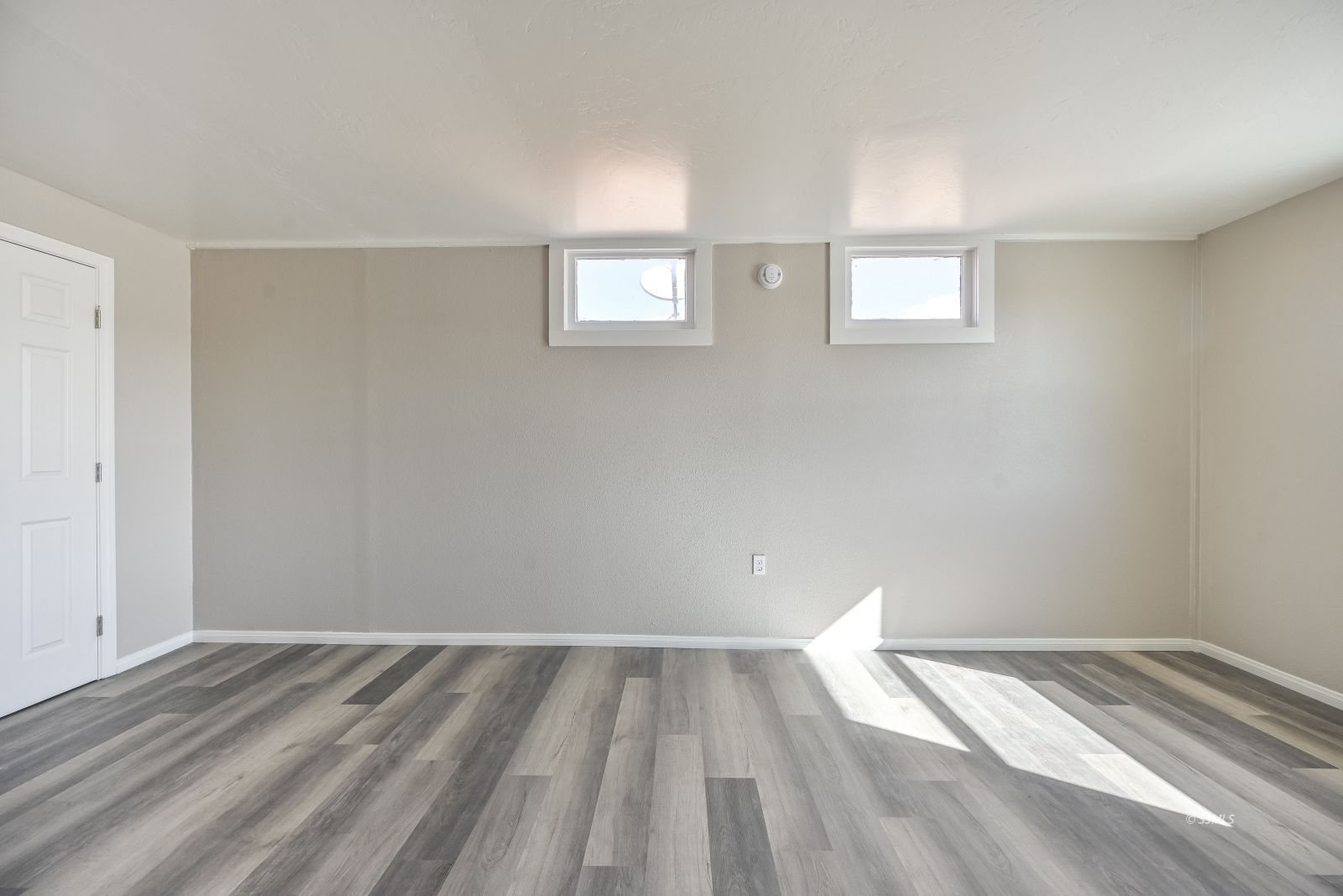 233 North Alvord Street Ridgecrest, CA 93555 - Photo 15 of 32 a view of a room with wooden floor and windows