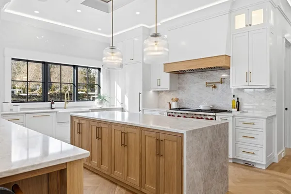 a kitchen with stainless steel appliances granite countertop a stove and a sink