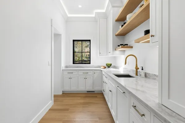 a kitchen with sink and cabinets