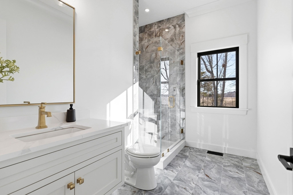 9 Tuttle Lane Lynnfield, MA 01940 - Photo 15 of 42 a bathroom with a toilet sink and mirror