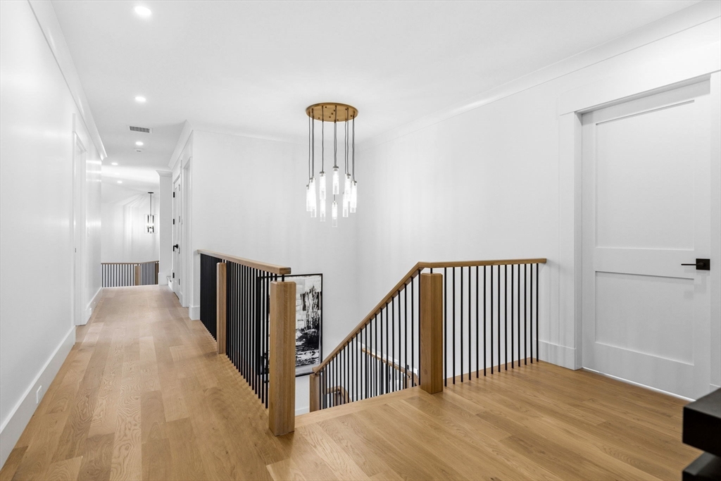 9 Tuttle Lane Lynnfield, MA 01940 - Photo 17 of 42 a view of a hallway with a chandelier