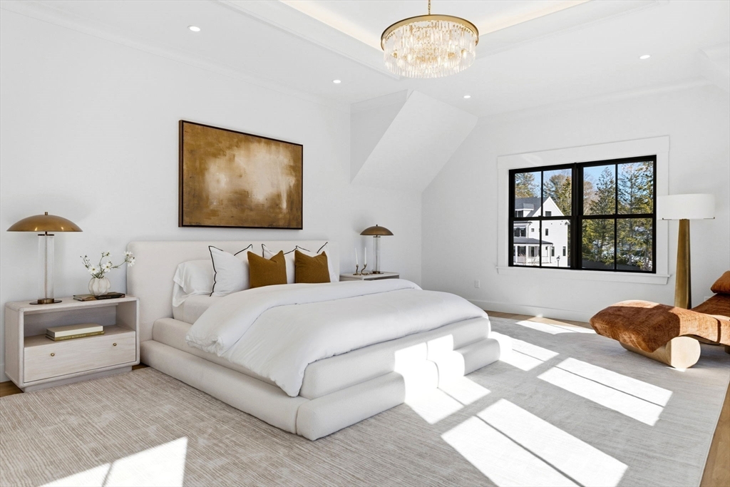 9 Tuttle Lane Lynnfield, MA 01940 - Photo 20 of 42 a bedroom with a large bed and a chandelier