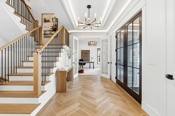 a view of entryway and hall with wooden floor