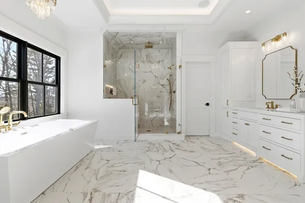 a bathroom with a granite countertop sink mirror and shower