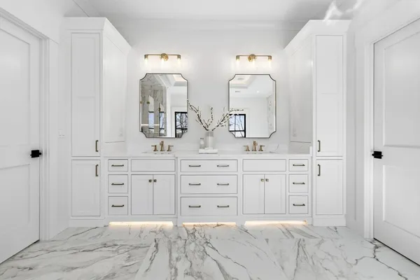 a spacious bathroom with double sink and a mirror