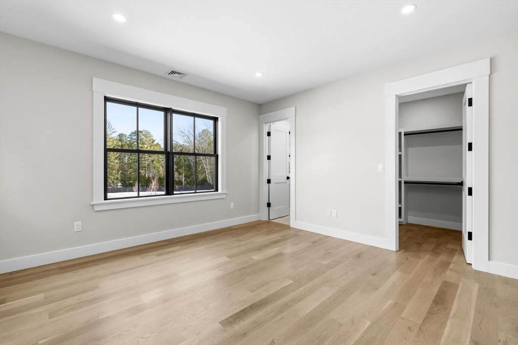 9 Tuttle Lane Lynnfield, MA 01940 - Photo 29 of 42 a view of an empty room with a window and wooden floor
