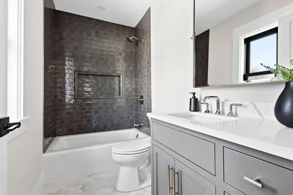 a bathroom with a sink a toilet and shower