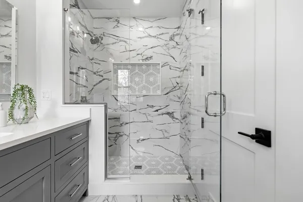 a bathroom with a shower and vanity