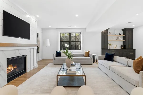 a living room with furniture fireplace and flat screen tv