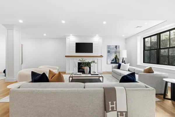 a living room with fireplace furniture and a flat screen tv