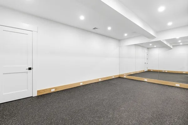 an empty room with a projector and white walls