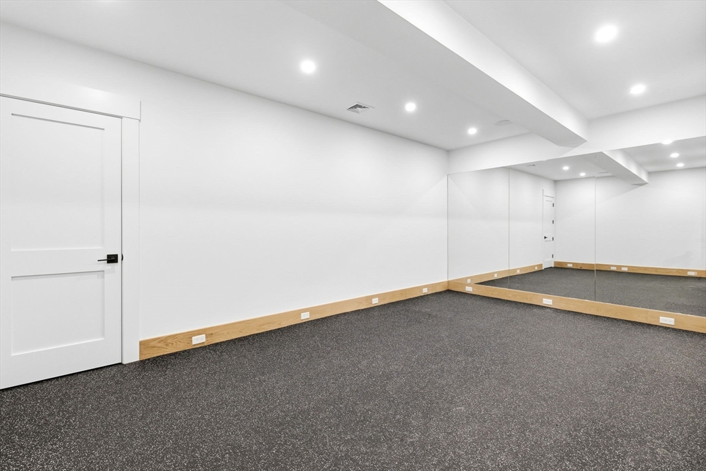 9 Tuttle Lane Lynnfield, MA 01940 - Photo 39 of 42 an empty room with a projector and white walls