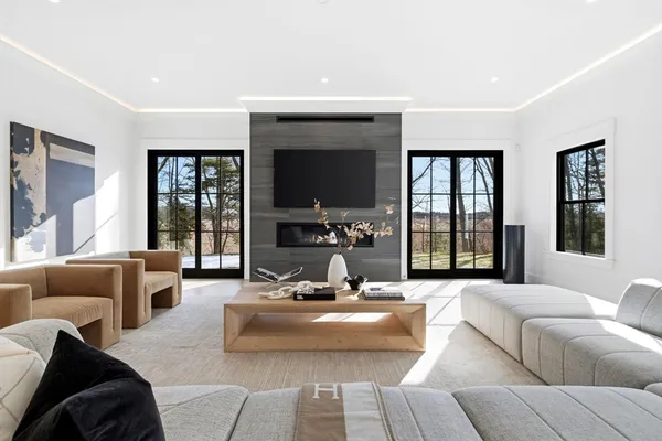 a living room with furniture and large windows