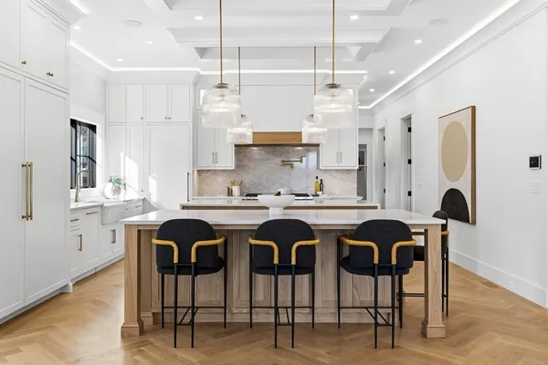 a kitchen with stainless steel appliances granite countertop a table and chairs in it
