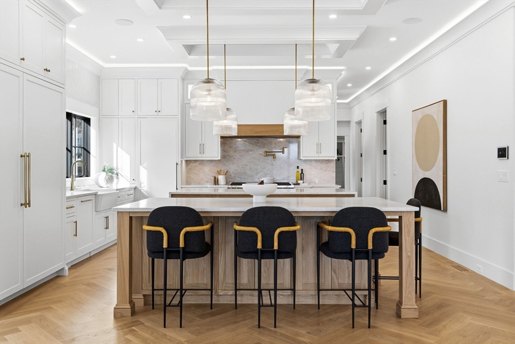 9 Tuttle Lane Lynnfield, MA 01940 - Photo 8 of 42 a kitchen with stainless steel appliances granite countertop a table and chairs in it