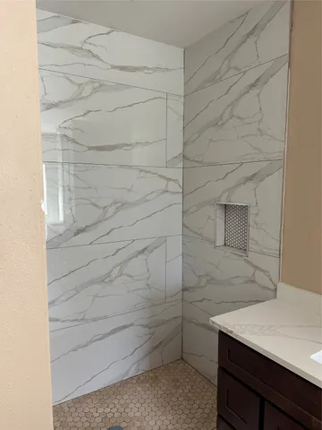 a bathroom with a sink and shower