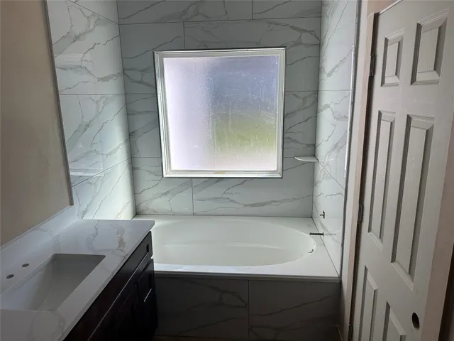 a bathroom with a sink and a bathtub