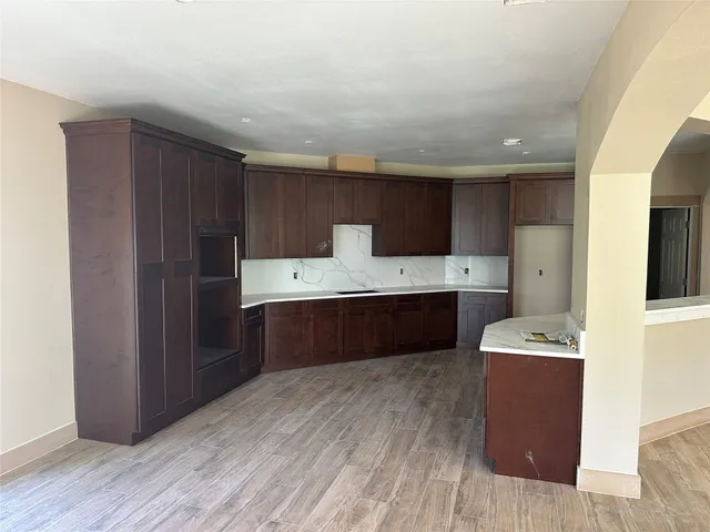 a large kitchen with a cabinets and wooden floor