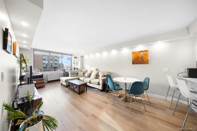 a living room with furniture and painting on the wall