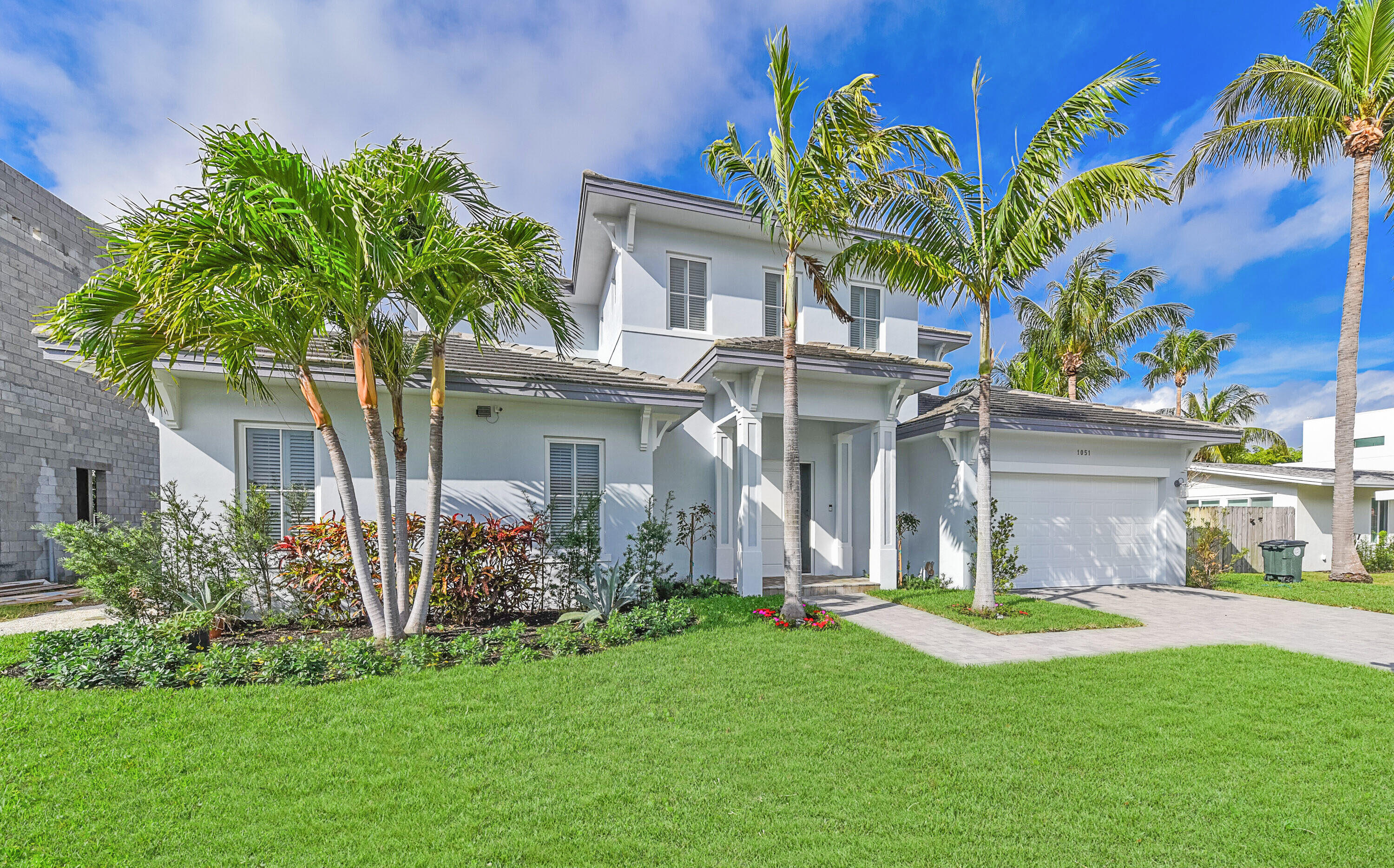 1051 Northeast 3rd Avenue Boca Raton, FL 33432 - Photo 1 of 1 a front view of a house with a garden and plants
