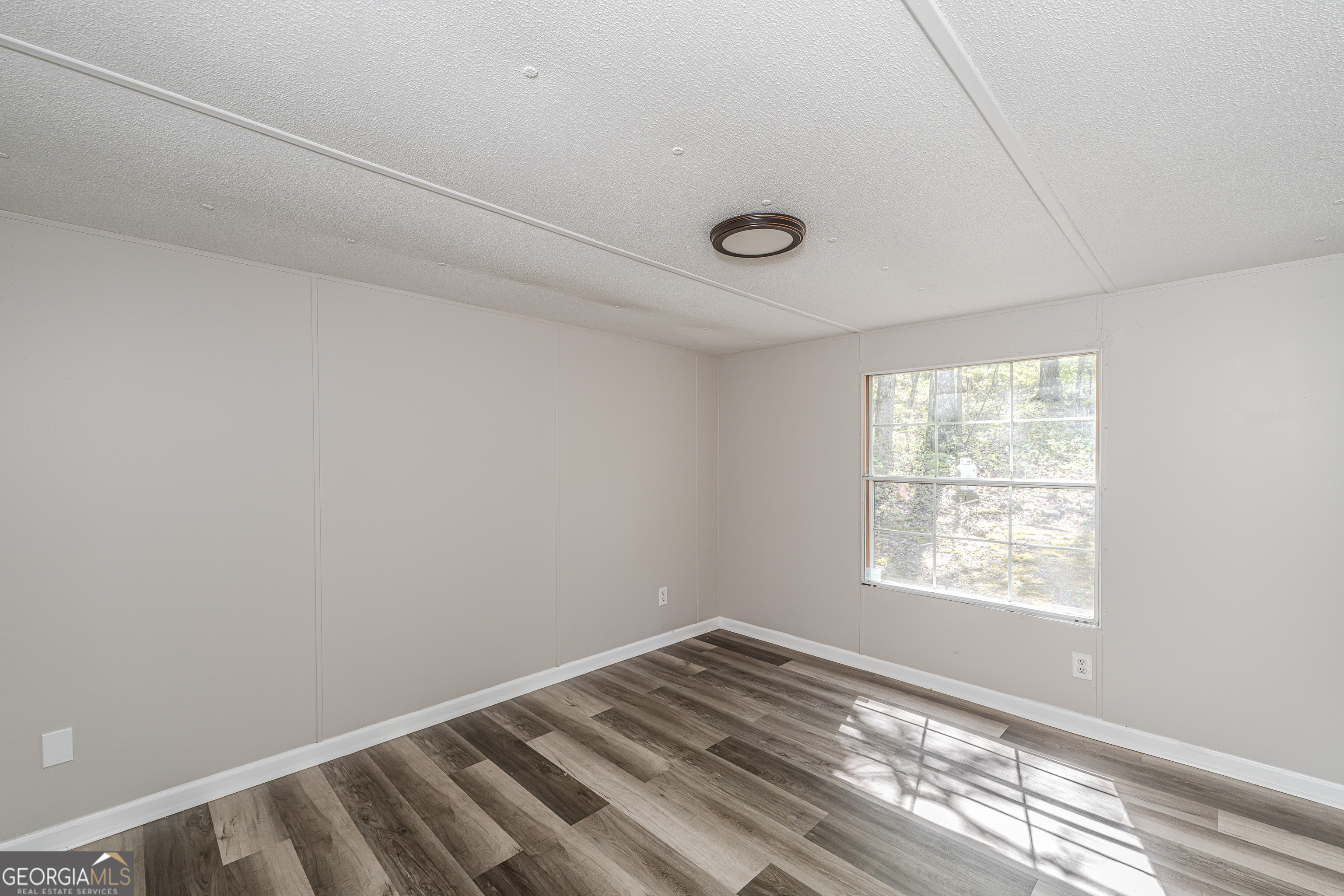 71 Kirk Road Northwest White, GA 30184 - Photo 34 of 43 a view of empty room with wooden floor and fan