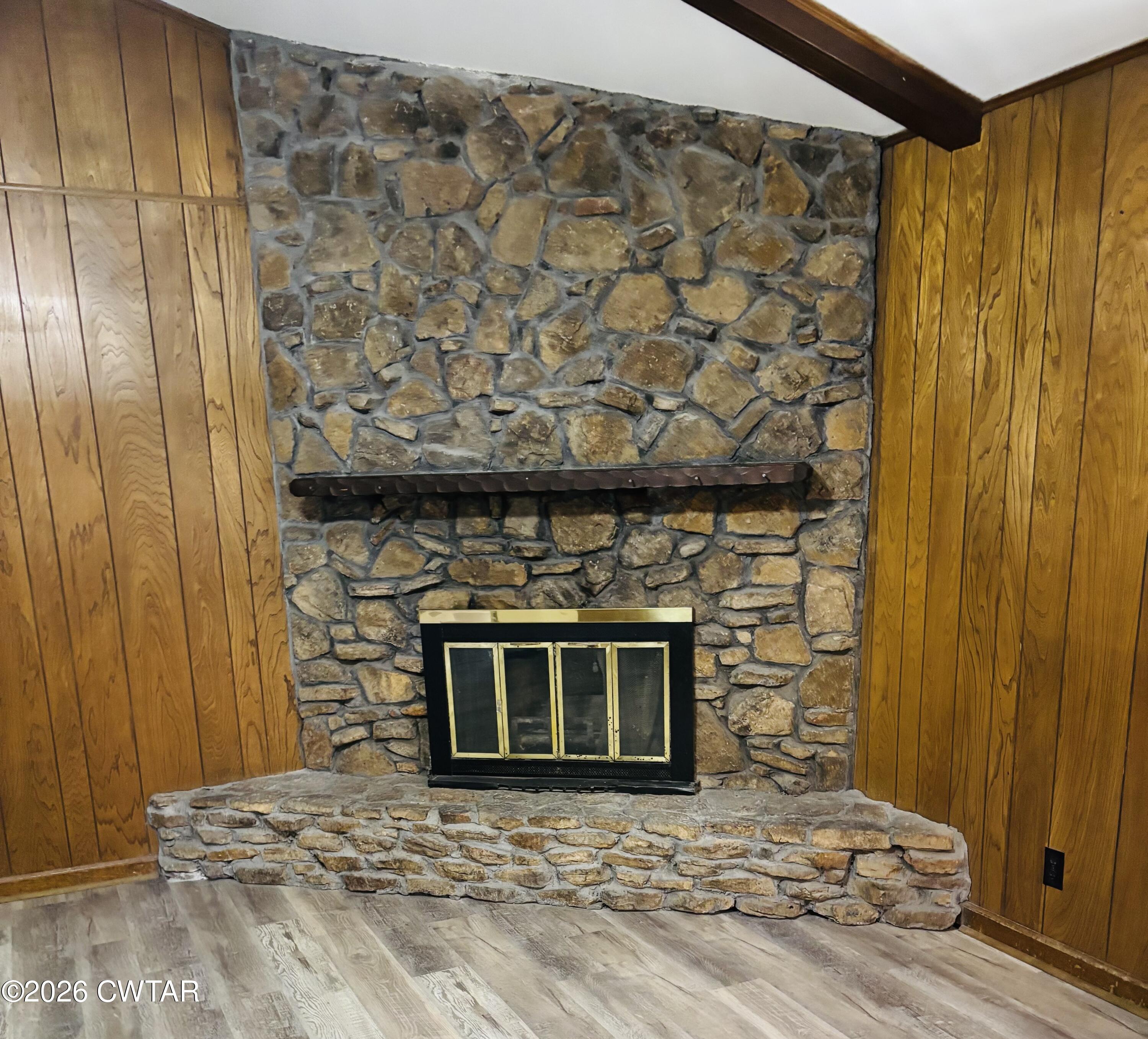 149 Commanche Trail Jackson, TN 38305 - Photo 3 of 15 a living room with a fireplace and a wooden floor