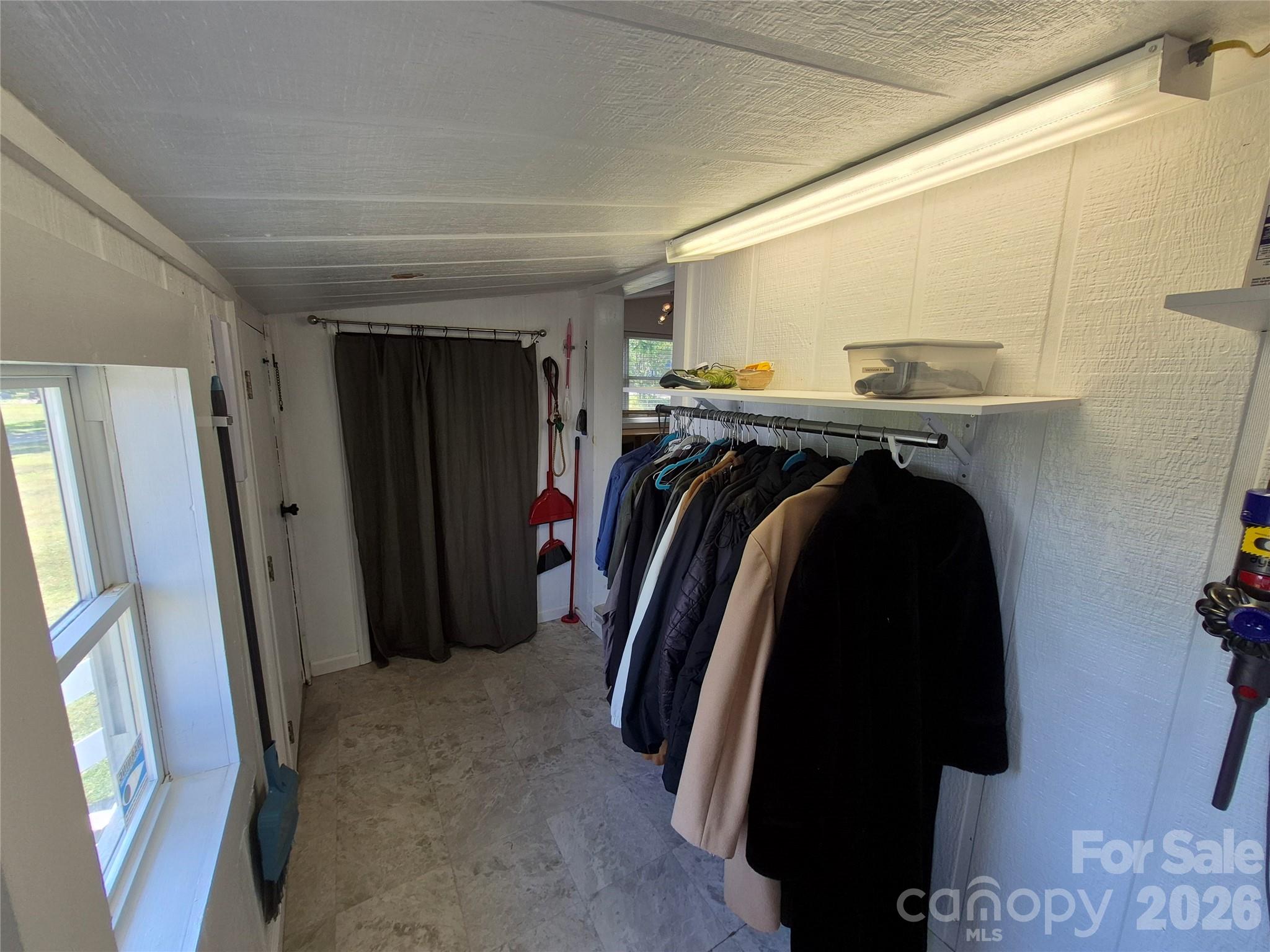 4438 Reepsville Road Vale, NC 28168 - Photo 24 of 32 a view of walk in closet with clothes and shoes