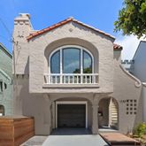 a living room with furniture a fireplace and a potted plant