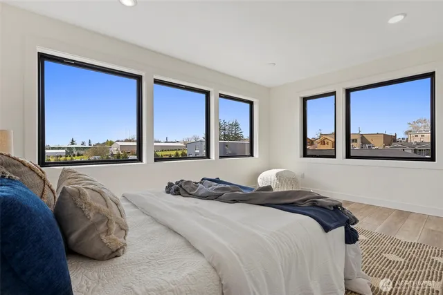 a bedroom with a large bed and a large window