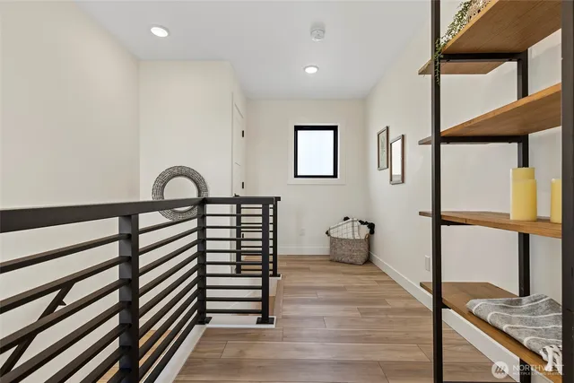 a view of entryway and hall with wooden floor