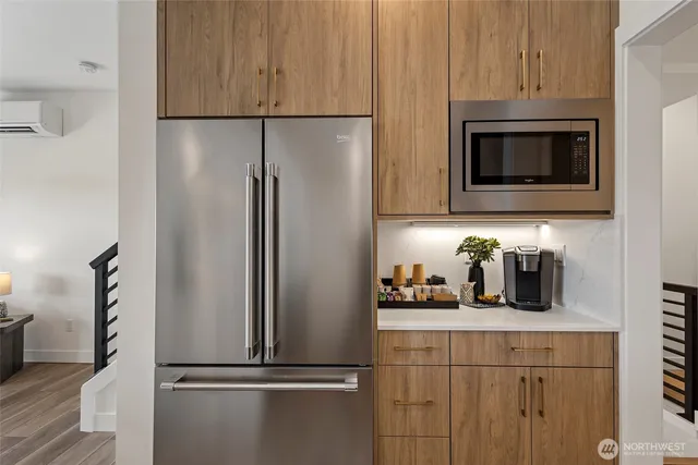 a kitchen with a refrigerator and microwave