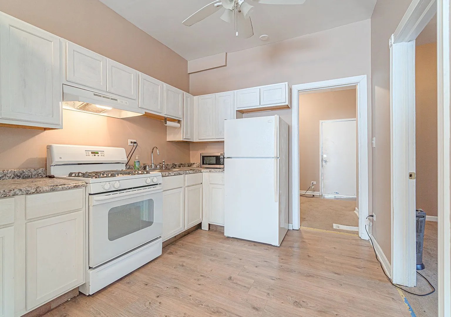 1144 West 68th Street, Unit 1 Chicago, IL 60621 - Photo 3 of 14 a kitchen with a refrigerator sink stove and cabinets