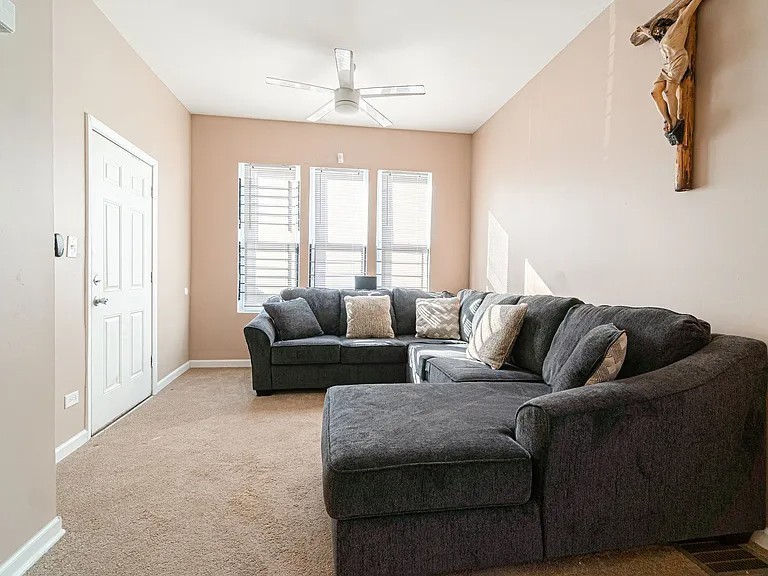 1144 West 68th Street, Unit 1 Chicago, IL 60621 - Photo 4 of 14 a living room with furniture and a large window