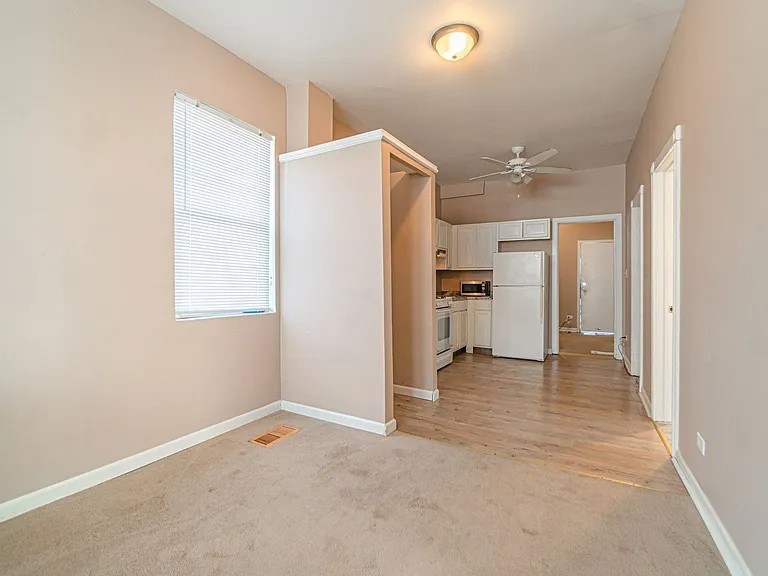 1144 West 68th Street, Unit 1 Chicago, IL 60621 - Photo 7 of 14 a view of a kitchen with a refrigerator and a sink