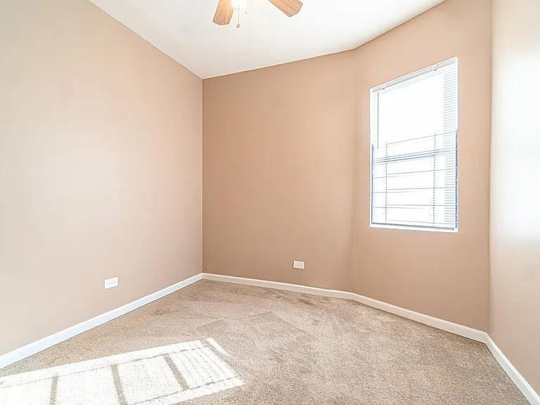 1144 West 68th Street, Unit 1 Chicago, IL 60621 - Photo 8 of 14 a view of an empty room with a window