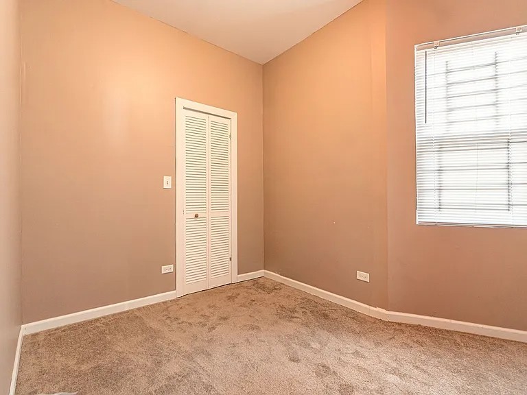 1144 West 68th Street, Unit 1 Chicago, IL 60621 - Photo 10 of 14 an empty room with windows